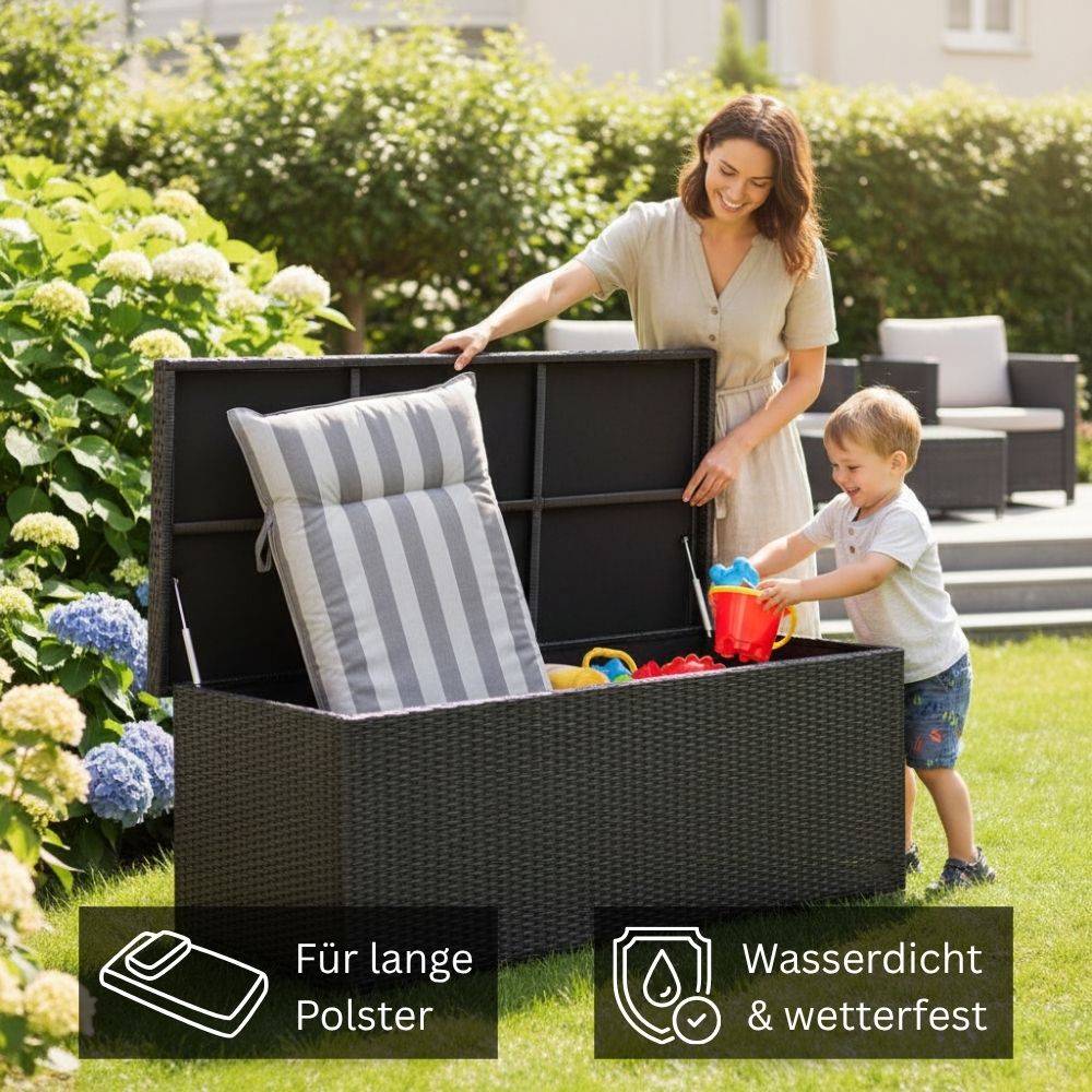 Graue Auflagenbox aus Polyrattan mit Stauraum für Sitzauflagen und Spielzeug im Garten; Person verstaut Gartenpolster in der wetterfesten Gartenbox.