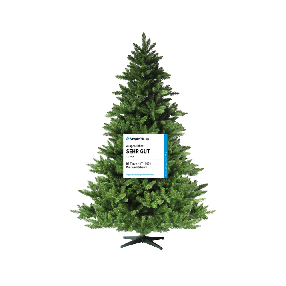 Künstlicher Tannenbaum mit Siegel "Sehr gut" am Stamm, dichtes Nadelwerk, schwarzer Kreuzfuß. 