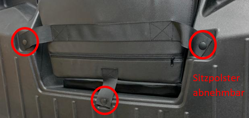 Detailaufnahme eines abnehmbaren Sitzpolsters an einer schwarzen ATV-Box, mit roten Markierungen.