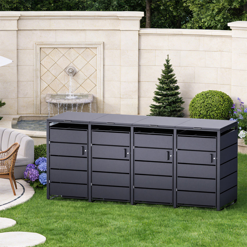 Vierfache Mülltonnenbox aus Metall in Anthrazit, freistehend auf gepflegtem Rasen.